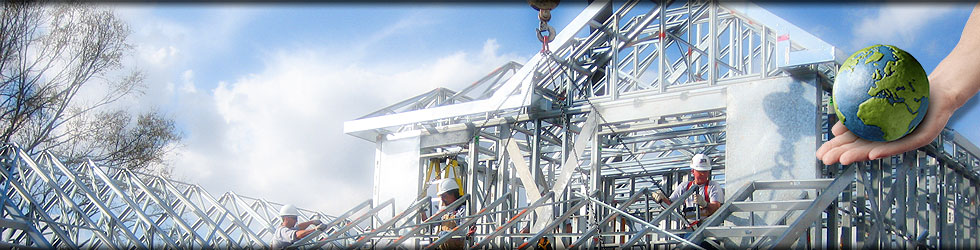 Construction site with workers installing a light steel framed house. the hand holding a green globe reflects the sustainable light steel building technology